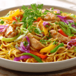 Best Chicken Lo Mein with tender chicken, colorful bell peppers, red cabbage, and green onions tossed with savory noodles in a white serving bowl.