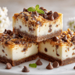 Chocolate Chip Cheesecake Bars with a rich chocolate crust, creamy cheesecake filling, and chocolate chips on top, served on a white marble platter.